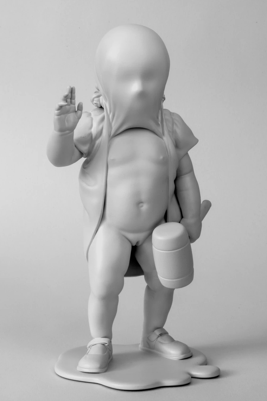 Vote, 2024 Vote, 2024. Monochrome sculpture of a child with a covered face, raised hand and toy hammer.